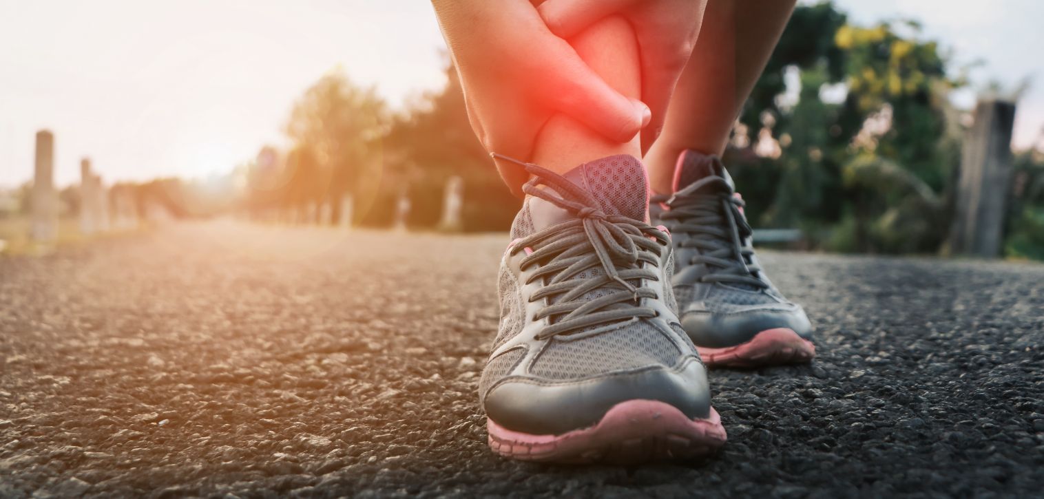 Closeup of a person holding their ankle