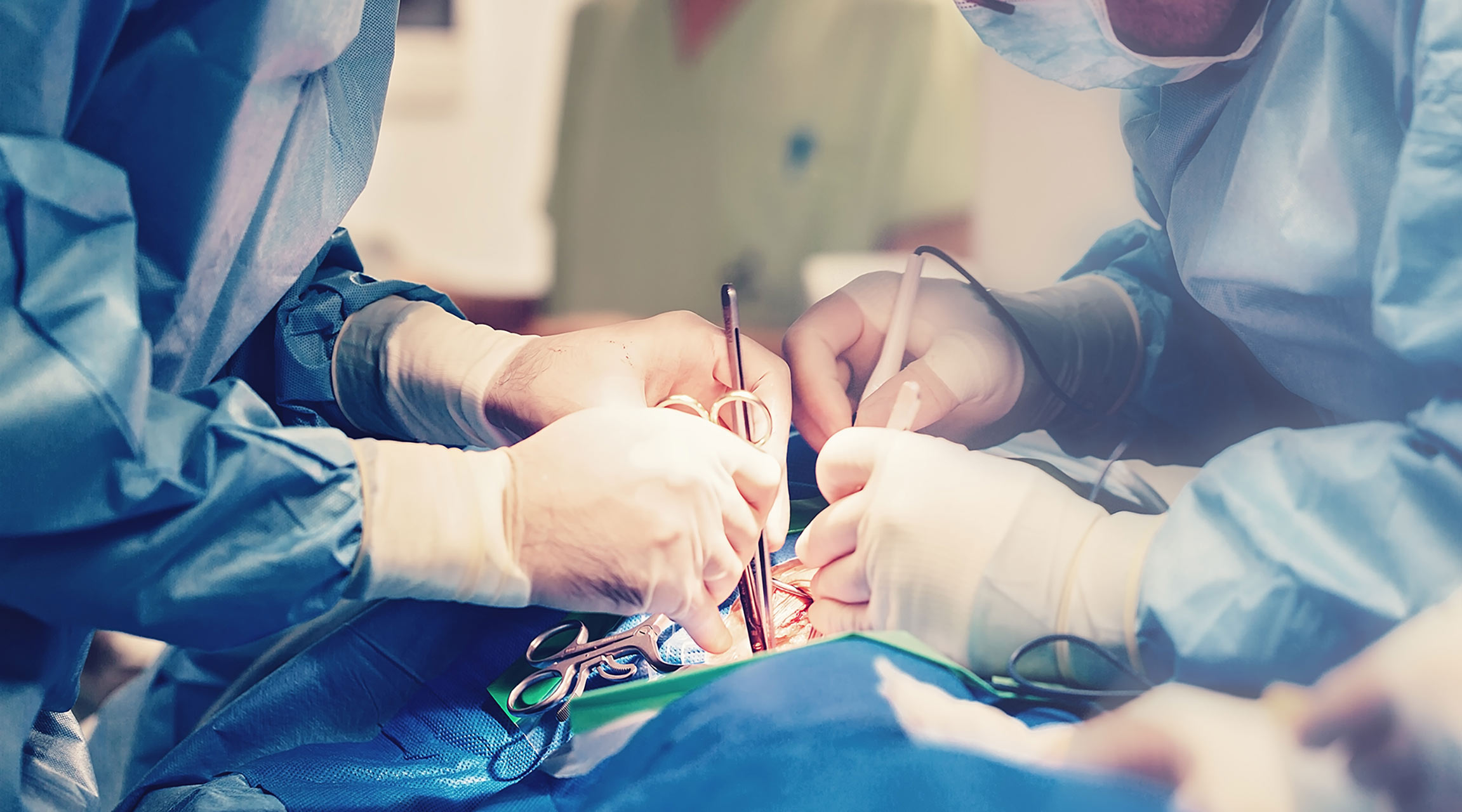 Close up image showing 2 surgeons working on an individual