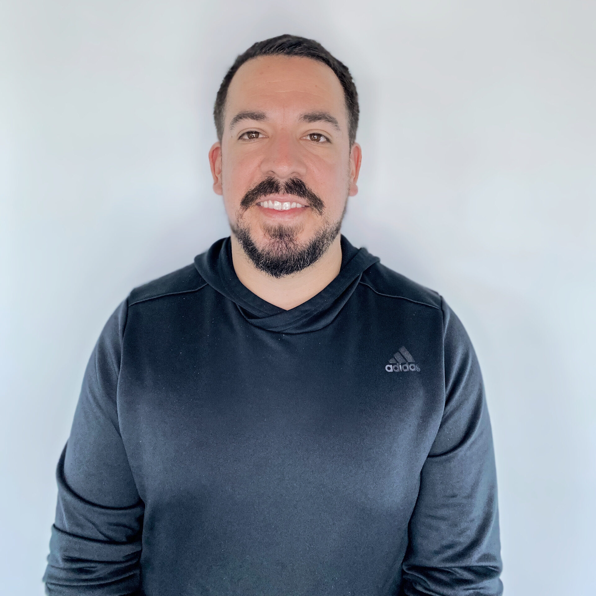 Art Rodriguez, PT, DPT Man with facial hair and red shirt smiling