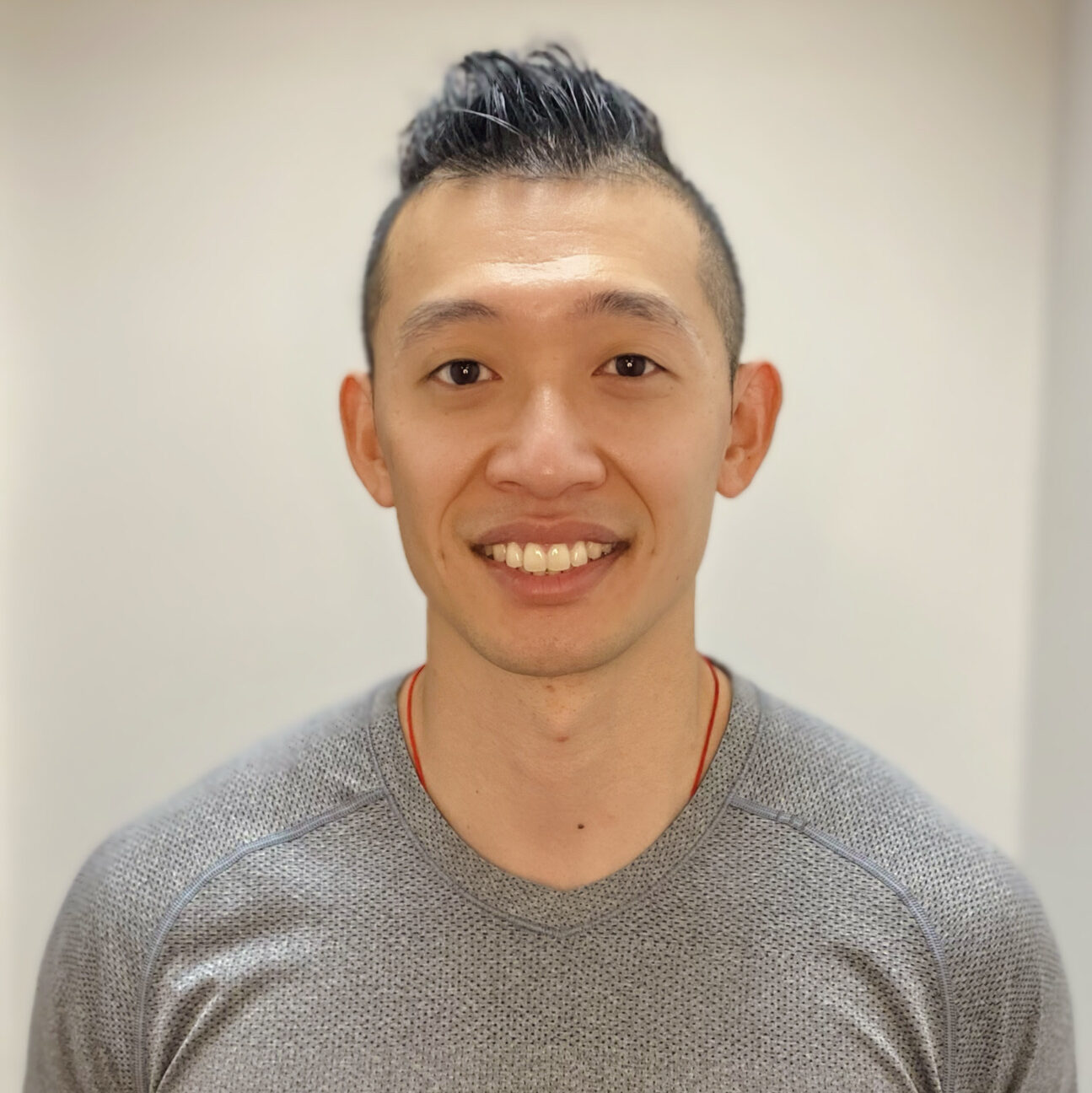 Paul Leung, PT, DPT Man with facial hair and red shirt smiling
