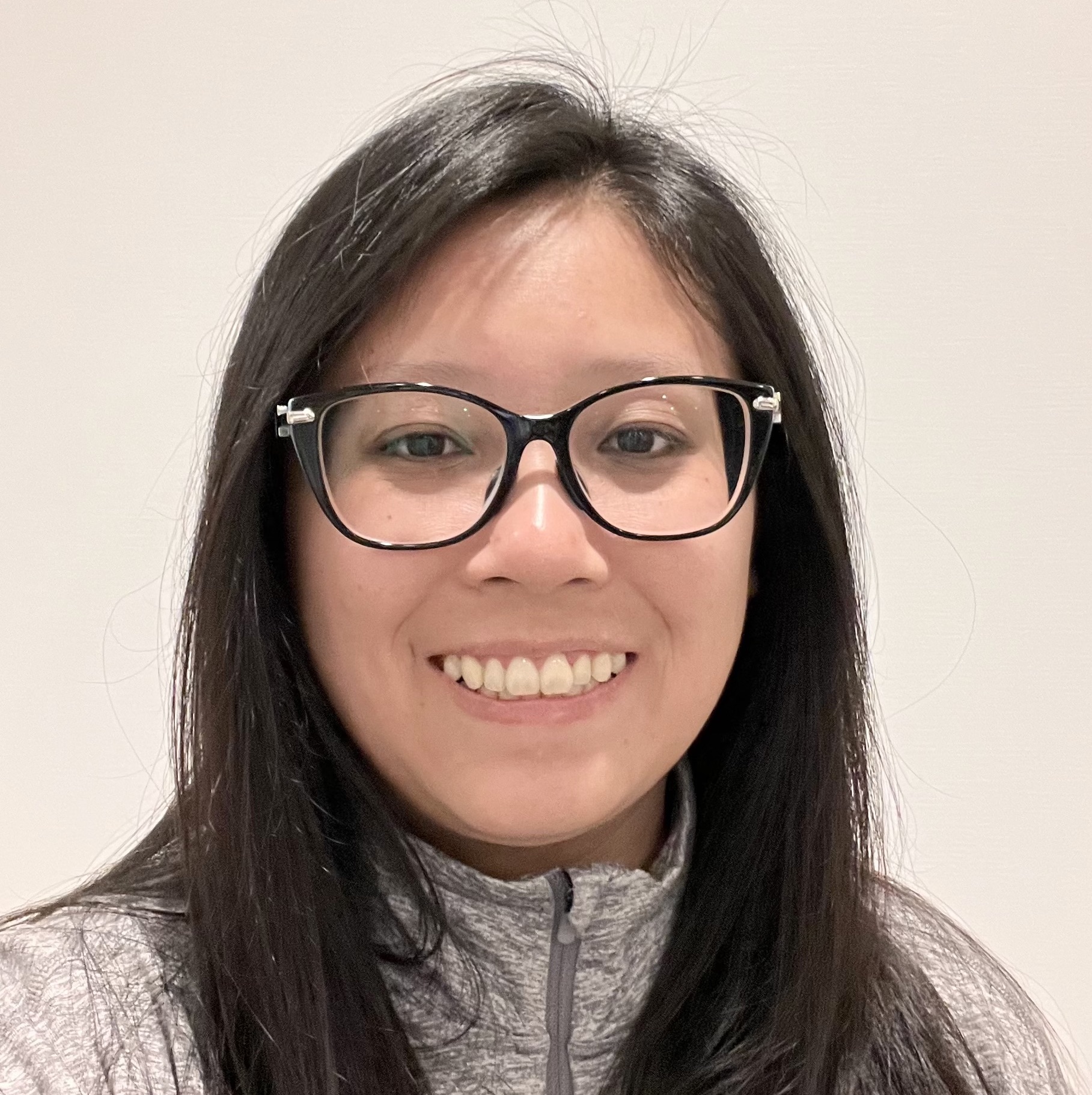 Bio Picture - Carina Huynh Man with facial hair and red shirt smiling